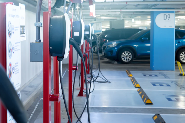 A parking lot with cars and charging stations