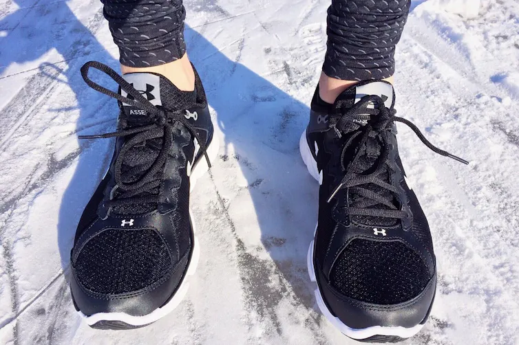 A runner's shoes standing in snow
