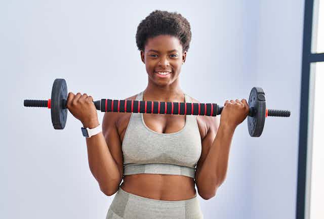 A woman holding a barbell