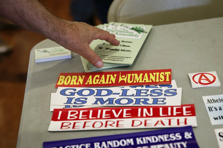 Stickers with messages such as 'Born again humanist' and 'I believe in life before death.'