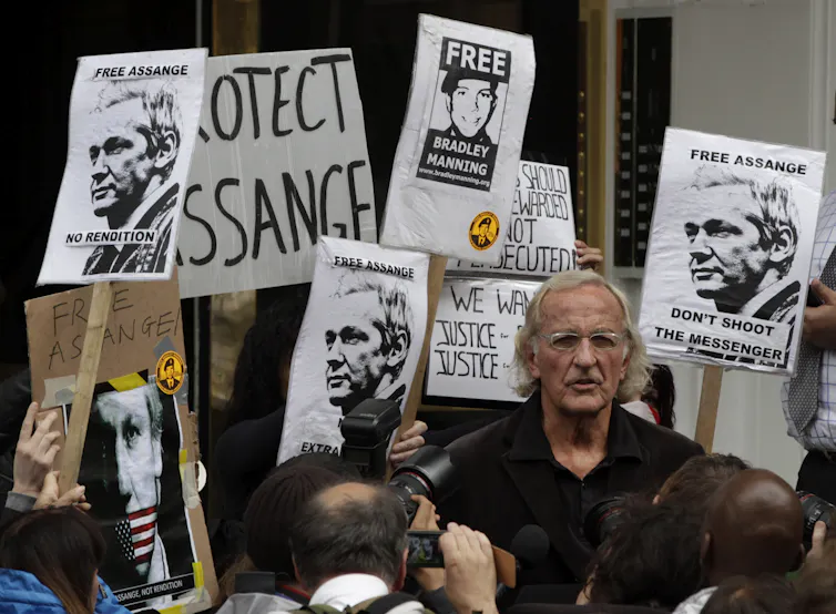 Journalist John Pilger joins a protest in support of Wikileaks.