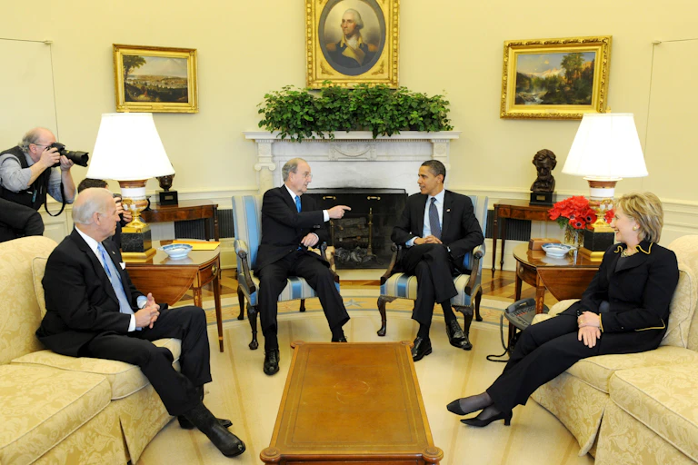 Joe Biden, George Mitchell, Barack Obama, Hillary Clinton sitting in the Oval Office, 2009