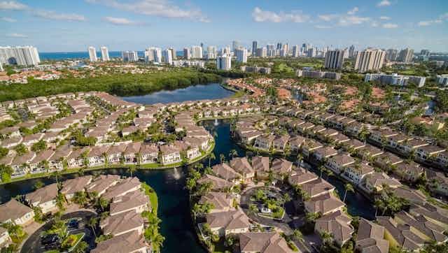 A residential neighborhood in Aventura, Florida, is seen in an aerial photograph. In the distance, the skyline of Sunny Isles Beach beckons.