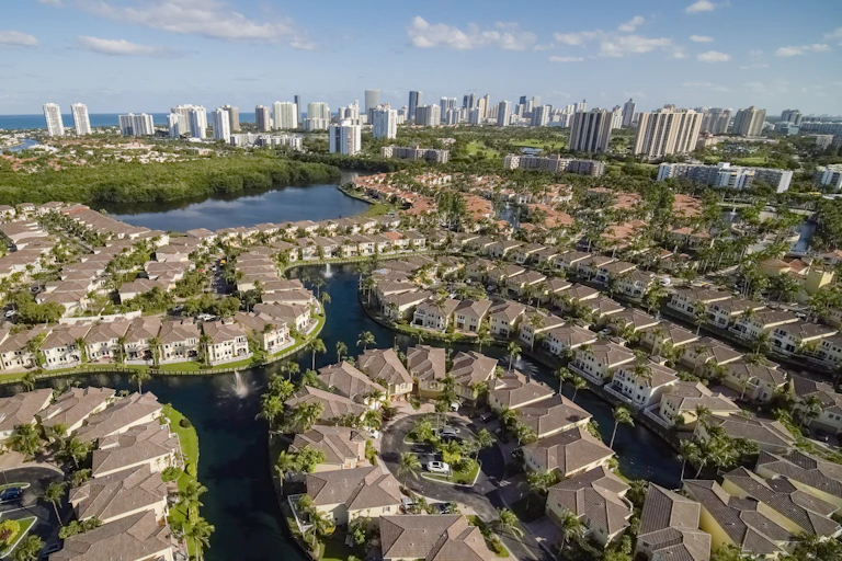 A residential neighborhood in Aventura, Florida, is seen in an aerial photograph. In the distance, the skyline of Sunny Isles Beach beckons.