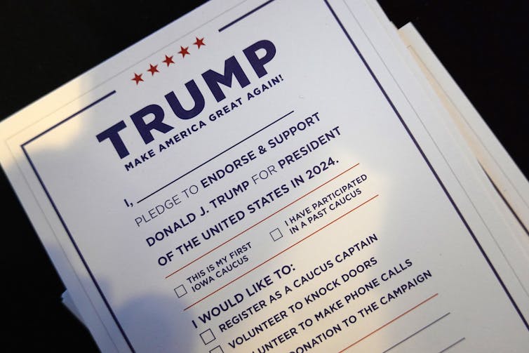A card with printing on it that asks people to sign up to work on the Trump campaign.