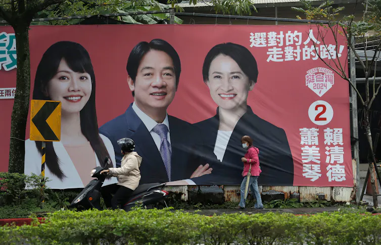 A large poster with three people's faces on it.