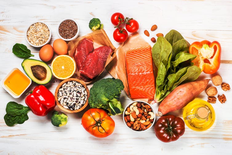 Overhead view of food including vegetables, eggs and meat.