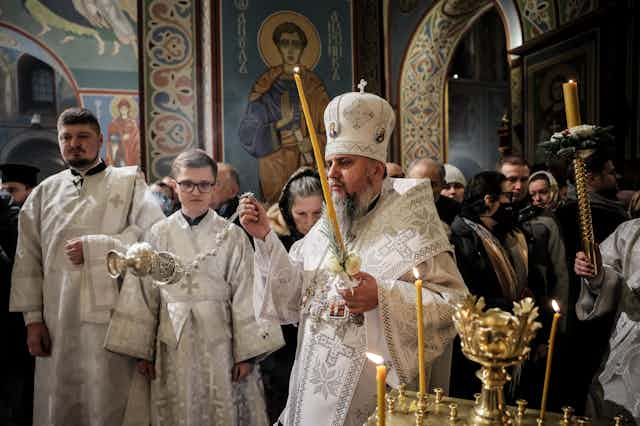 Ukraine's Orthodox patriarch, Metropolitan Epiphanius  of Kyiv, surr9ounded by church members in religious robes.