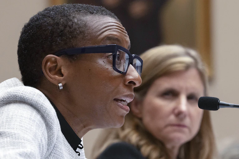 Two women speak into microphones