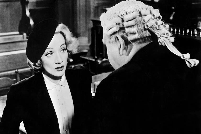 Black and white photo of a well dressed woman and man in courtroom wig