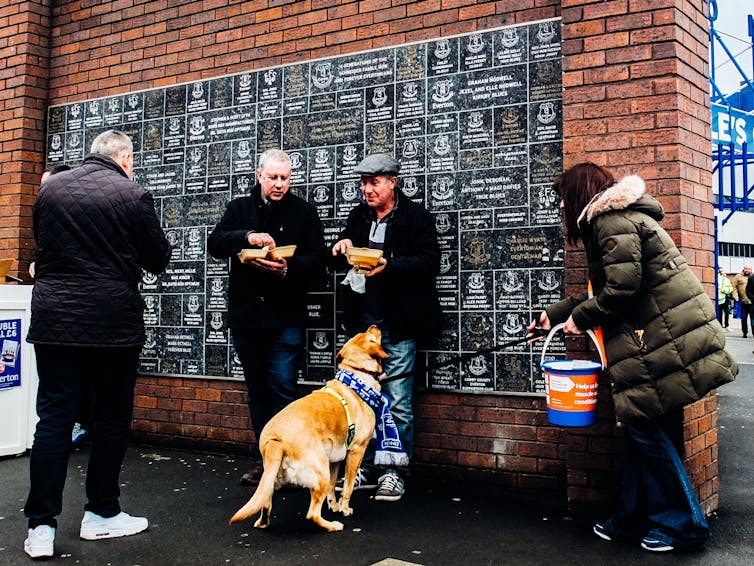 Three men, a woman and a dog.