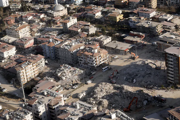 An aerial photo of a city with damaged buildings