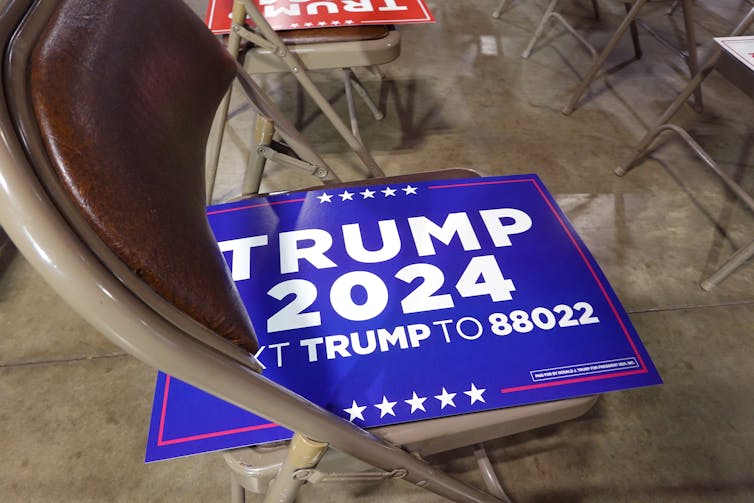 A blue sign with white printing that says 'Trump 2024.'
