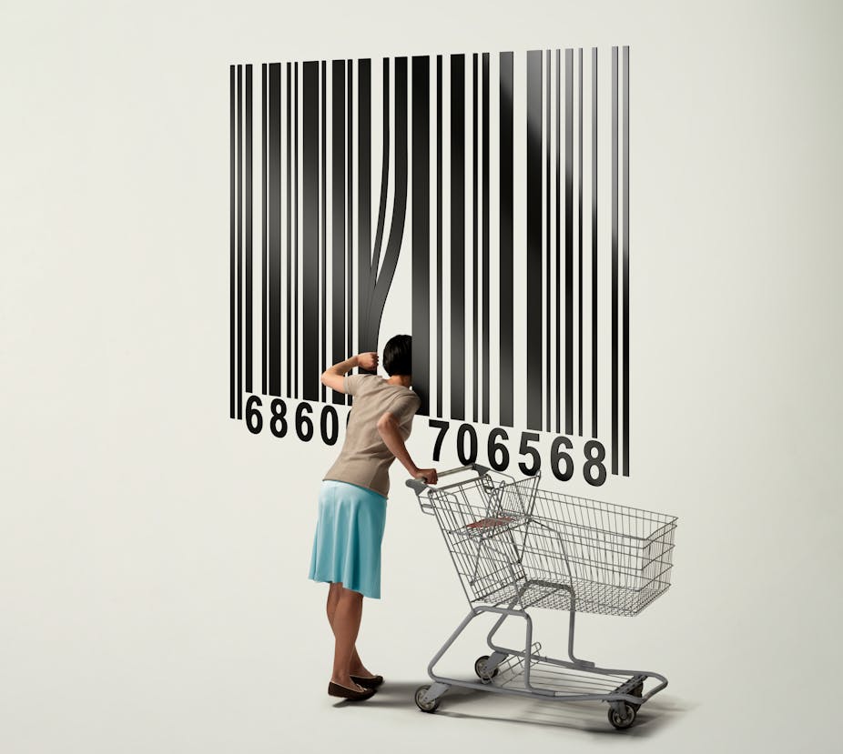 In an illustration, a woman with a shopping card peers inside a giant bar code.