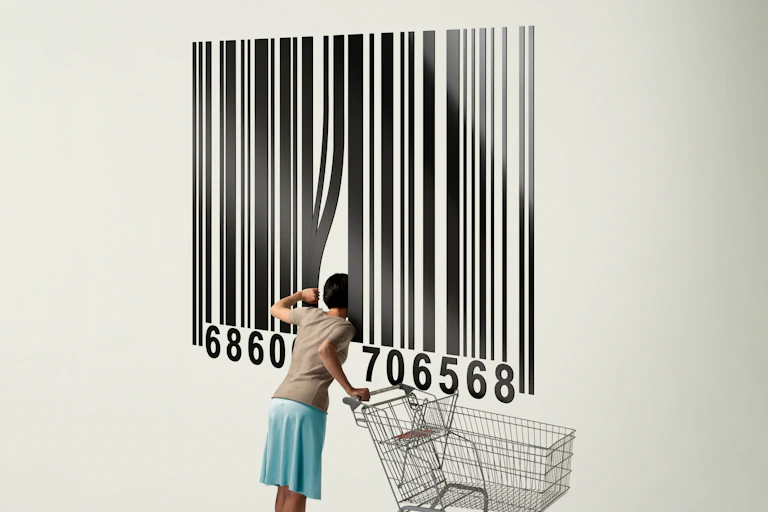 In an illustration, a woman with a shopping card peers inside a giant bar code.
