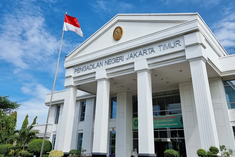 Exterior of large, white court building with four columns in Jakarta, Indonesia