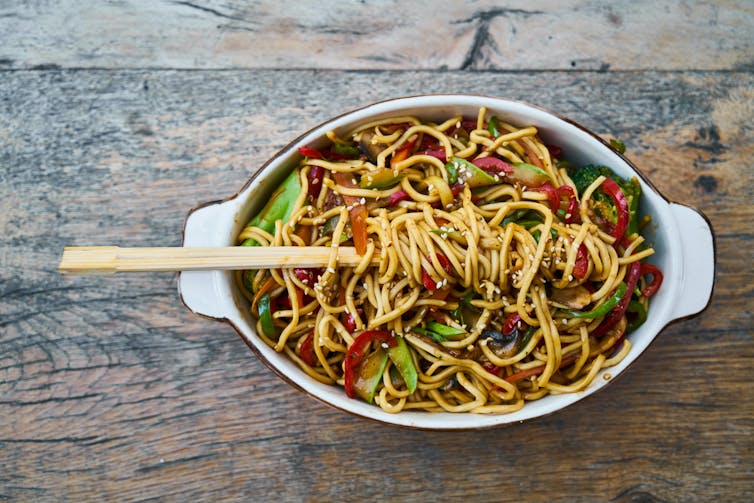 A pot full of noodles and vegetables.