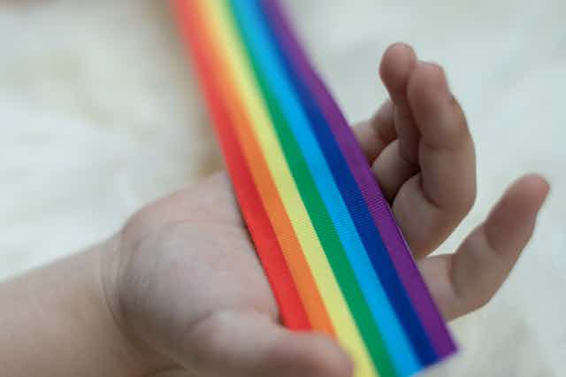 Rainbow flag in child's hand