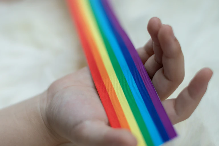 Rainbow flag in child's hand