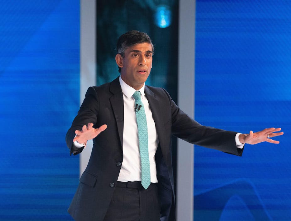 Rishi Sunak gesturing for people to be calm