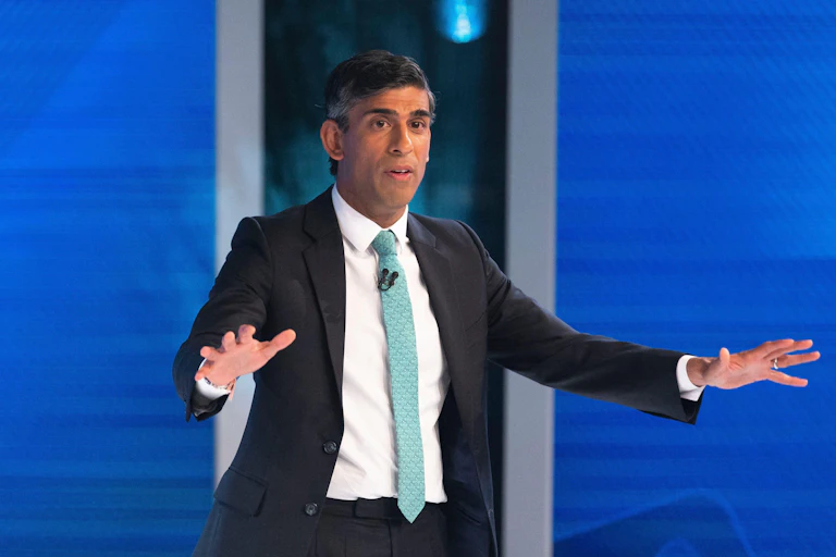 Rishi Sunak gesturing for people to be calm