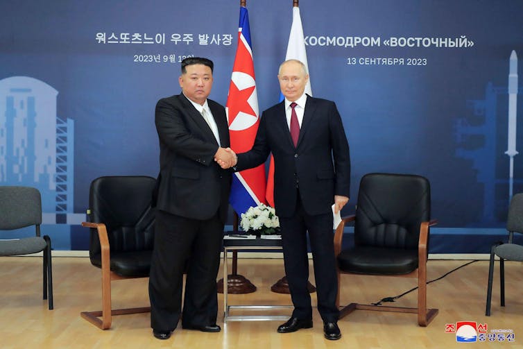 North Korean leader Kim Jong Un, left, and Russian President Vladimir Putin, right, shake hands.