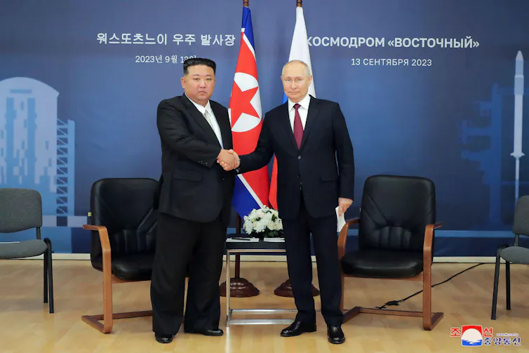 North Korean leader Kim Jong Un, left, and Russian President Vladimir Putin, right, shake hands.