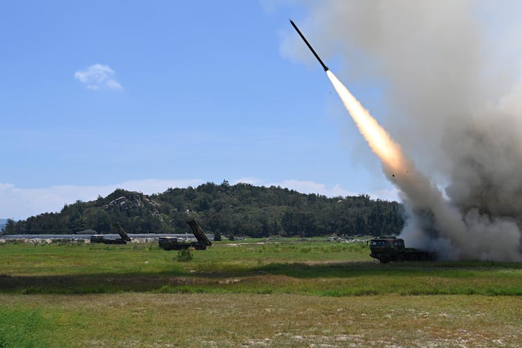 A missile being launched from a military vehicle.