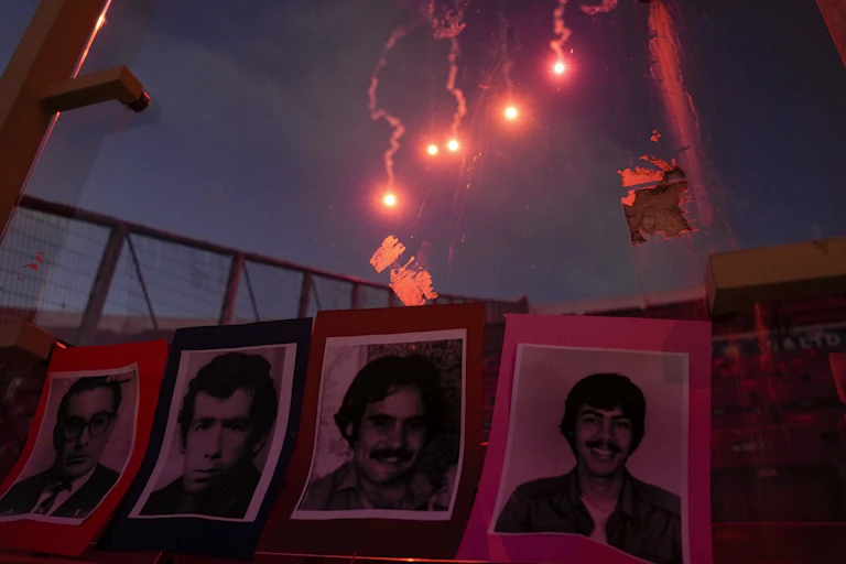 Black and white photos of people with red fireworks in the background