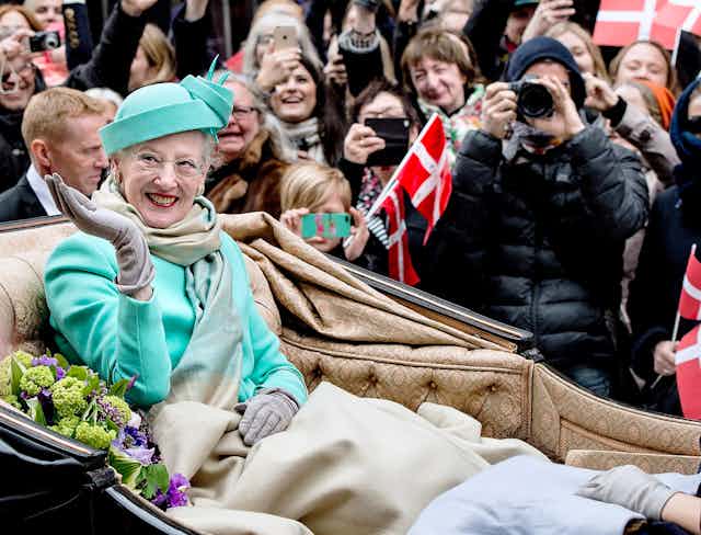 Queen Margrethe with a smile and a wave