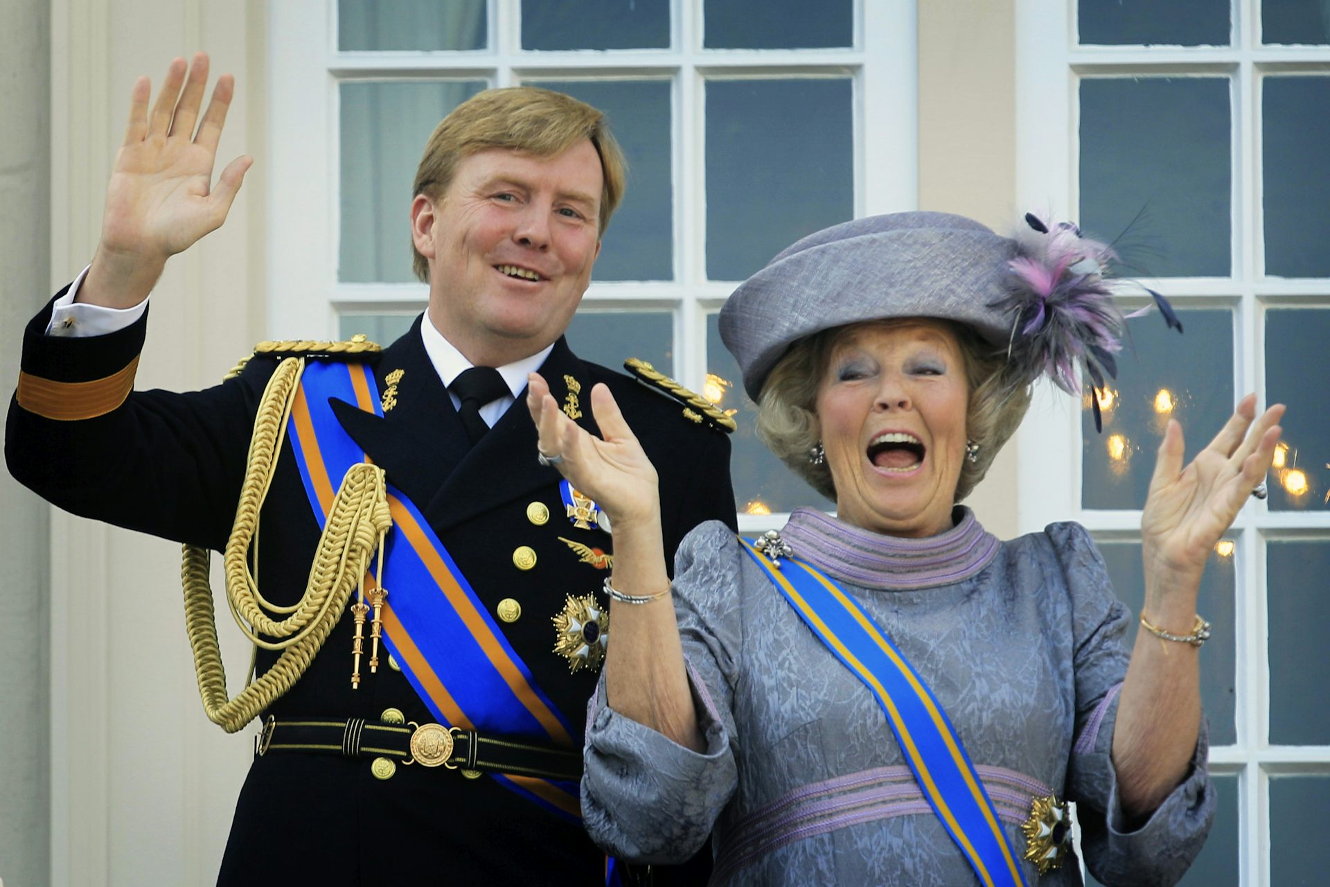 The pair wave to well wishers from the balcony of Royal Palace.