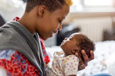 A woman holds her newborn baby.