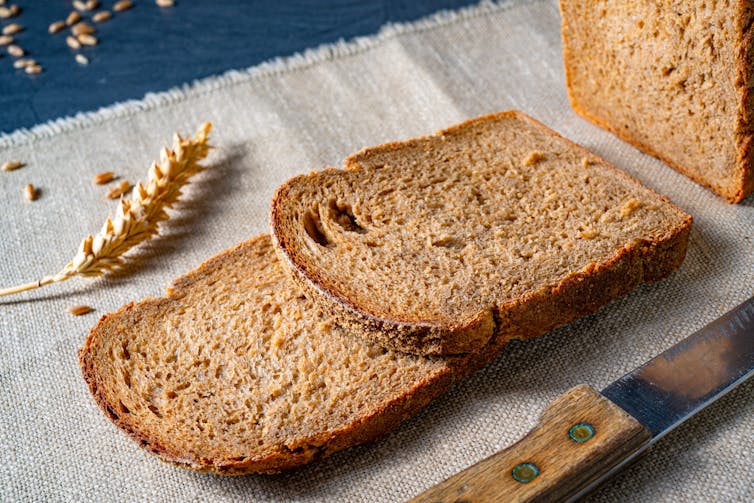 A loaf of sliced brown bread.