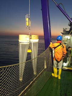 Bongo-shaped nets being lowered into the sea.