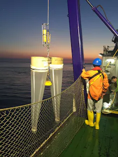 Bongo-shaped nets being lowered into the sea.