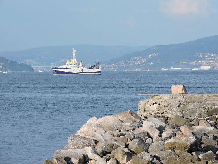 A boat sailing through a bay.