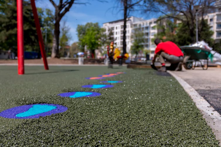 A close-up view of a crumb rubber surface in a playground.