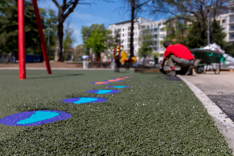 A close-up view of a crumb rubber surface in a playground.