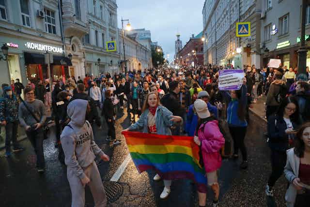 A woman holds up a rainbow flag during a demonstration against discrimination in Moscow, 2020