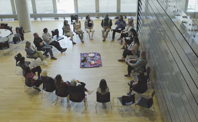 People sitting in a circle on chairs