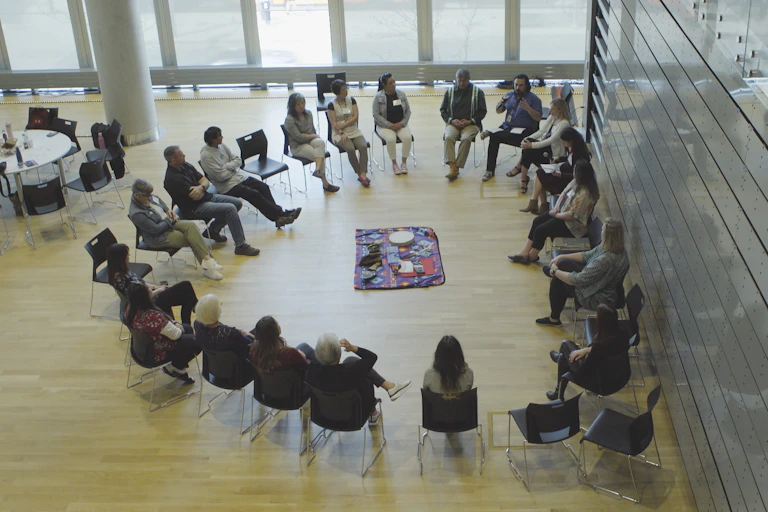 People sitting in a circle on chairs