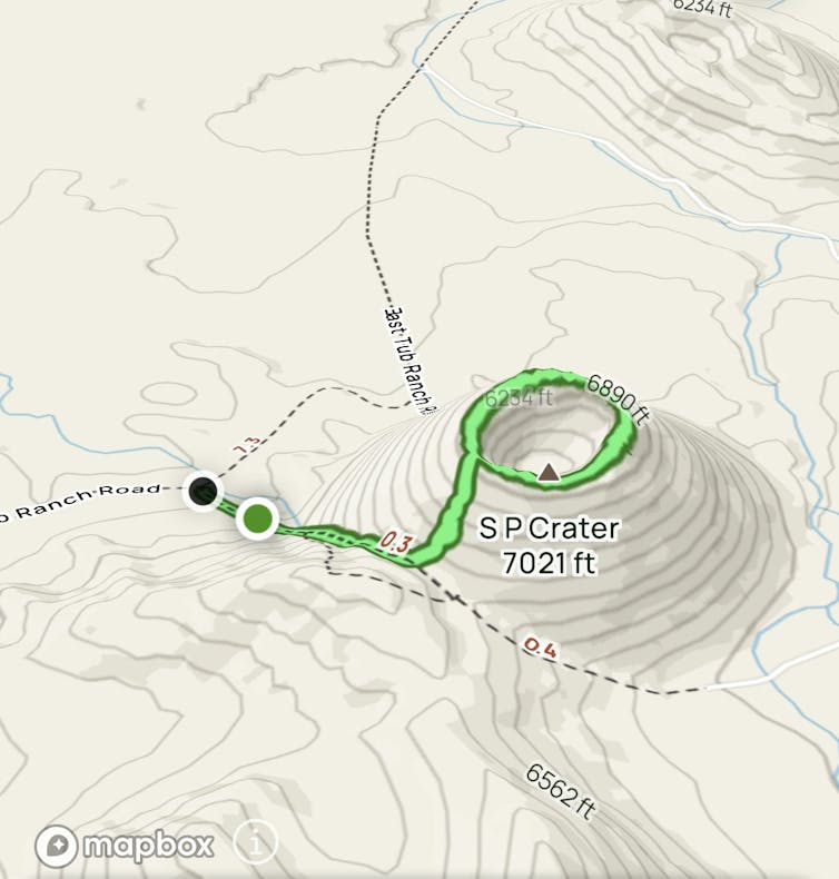 A digital map showing a crater, with a green circle indicating the path walked, around the lip of the crater.