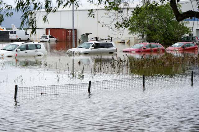 Cars standing in floodwaters in a Cairns suburb hit by Cyclone Jasper