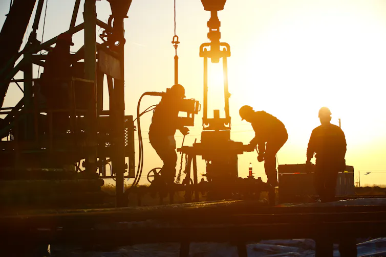 Oil workers drilling for oil.