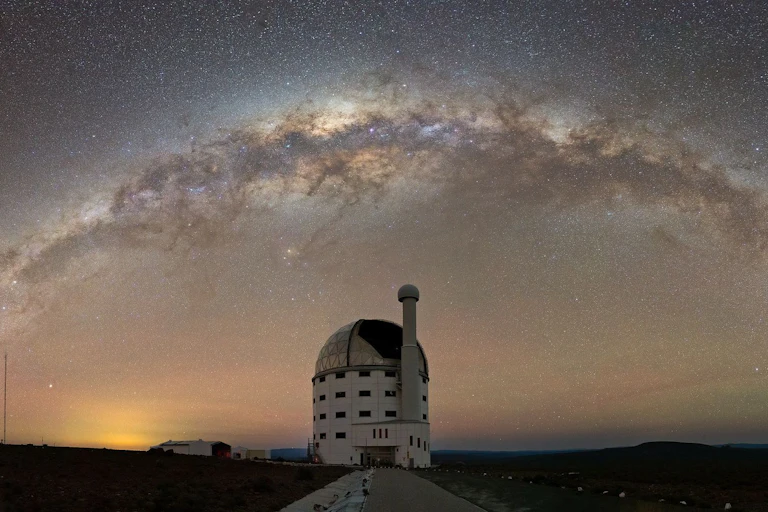 Domed structure against a starry night sky.