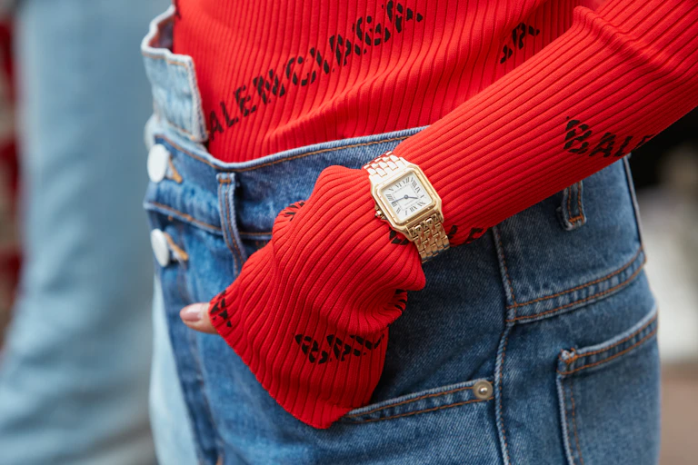 Woman wearing a red Balenciaga sweater.