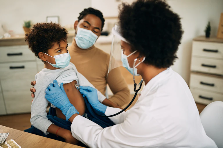 woman doctor examining a child