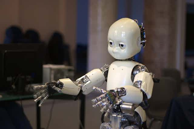 a humanoid robot with white plastic skin