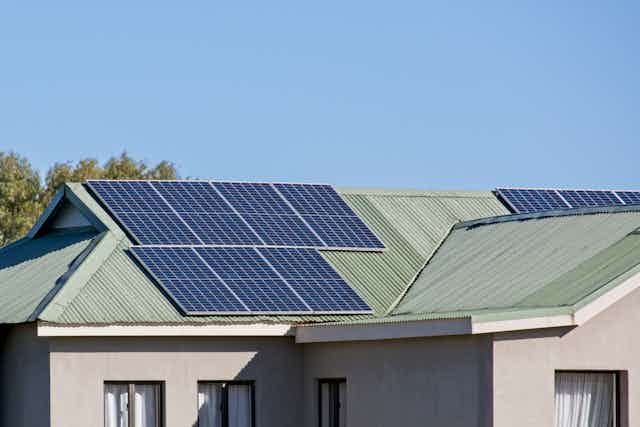 An ordinary house with about 18 solar panels on the roof