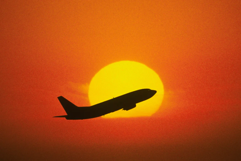Boeing 737 rising up into a sunset